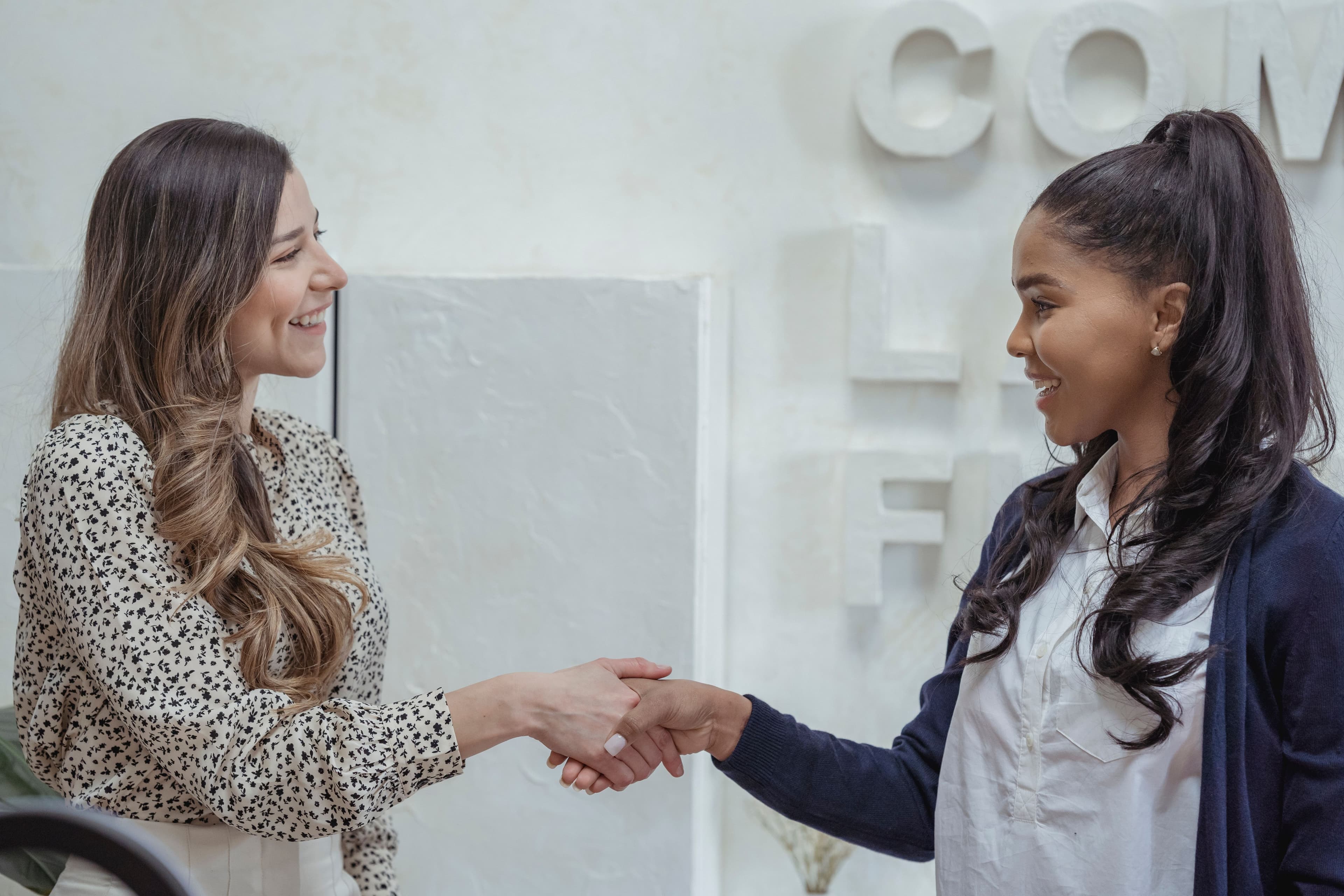 Two professionals shaking hands after a successful hire